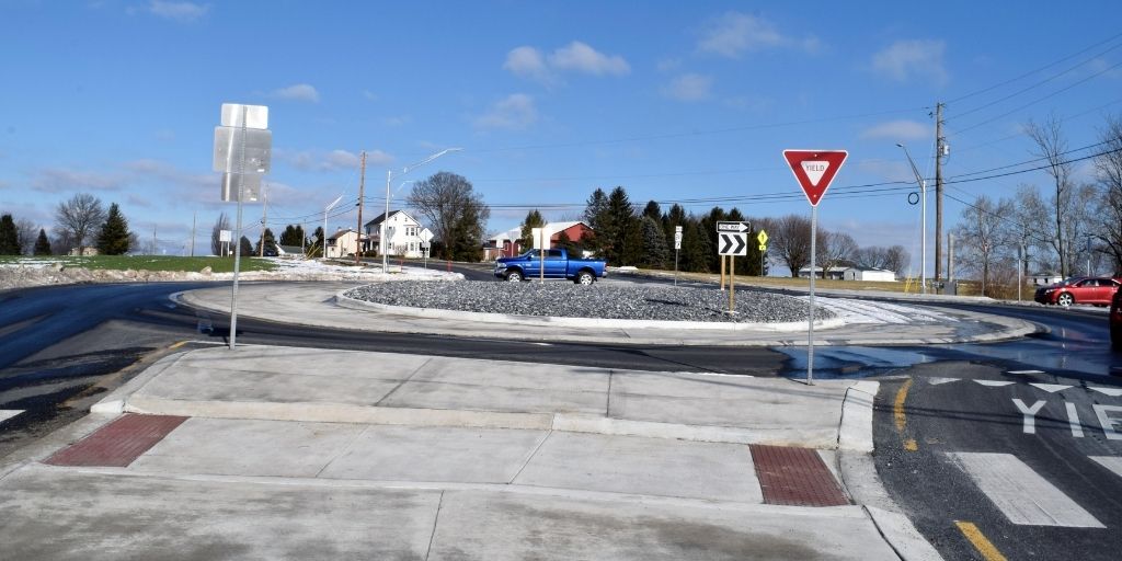 A pickup truck drives around the new roundabout.
